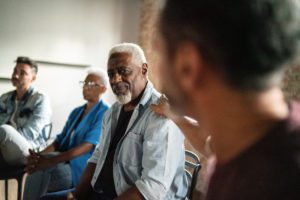 Man receiving support at a bereavement session.