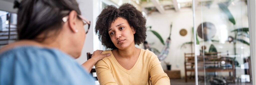 Young woman trying to remain strong for her elderly mother despite experiencing burnout